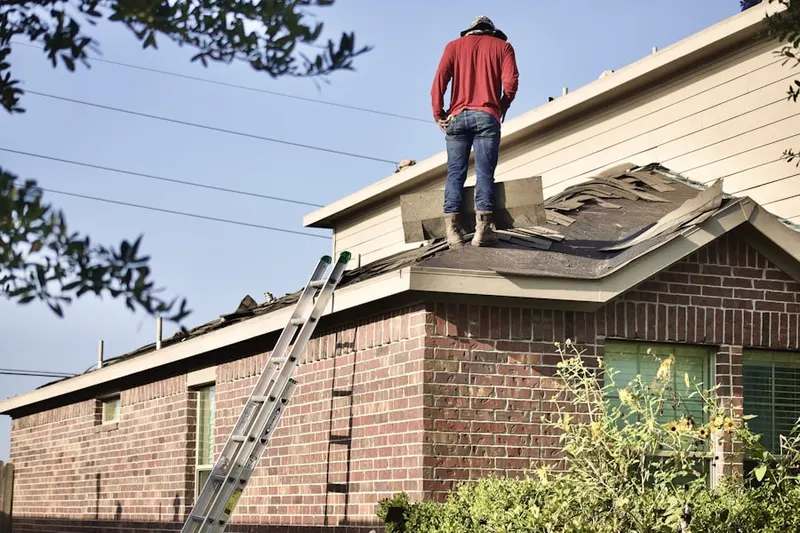 Professional roofer working on a residential roof in Lochbuie
